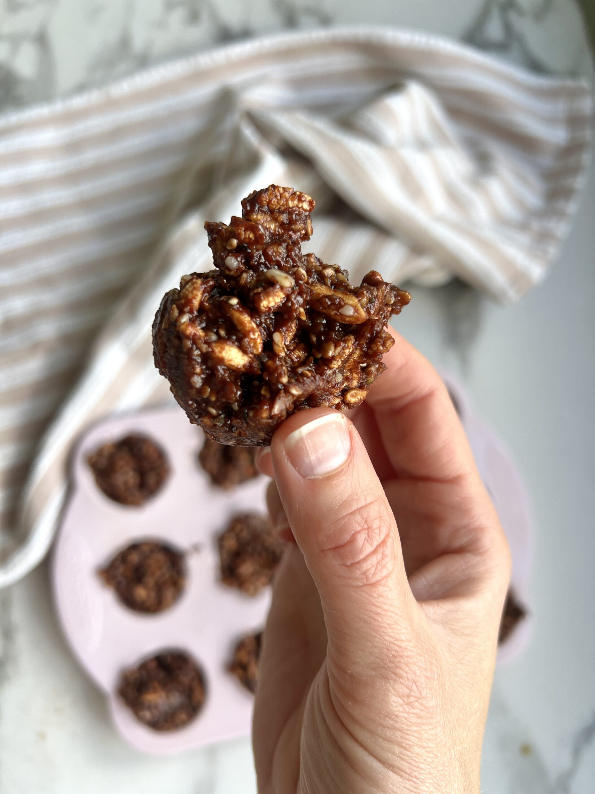 A hand holding chocolate crackles