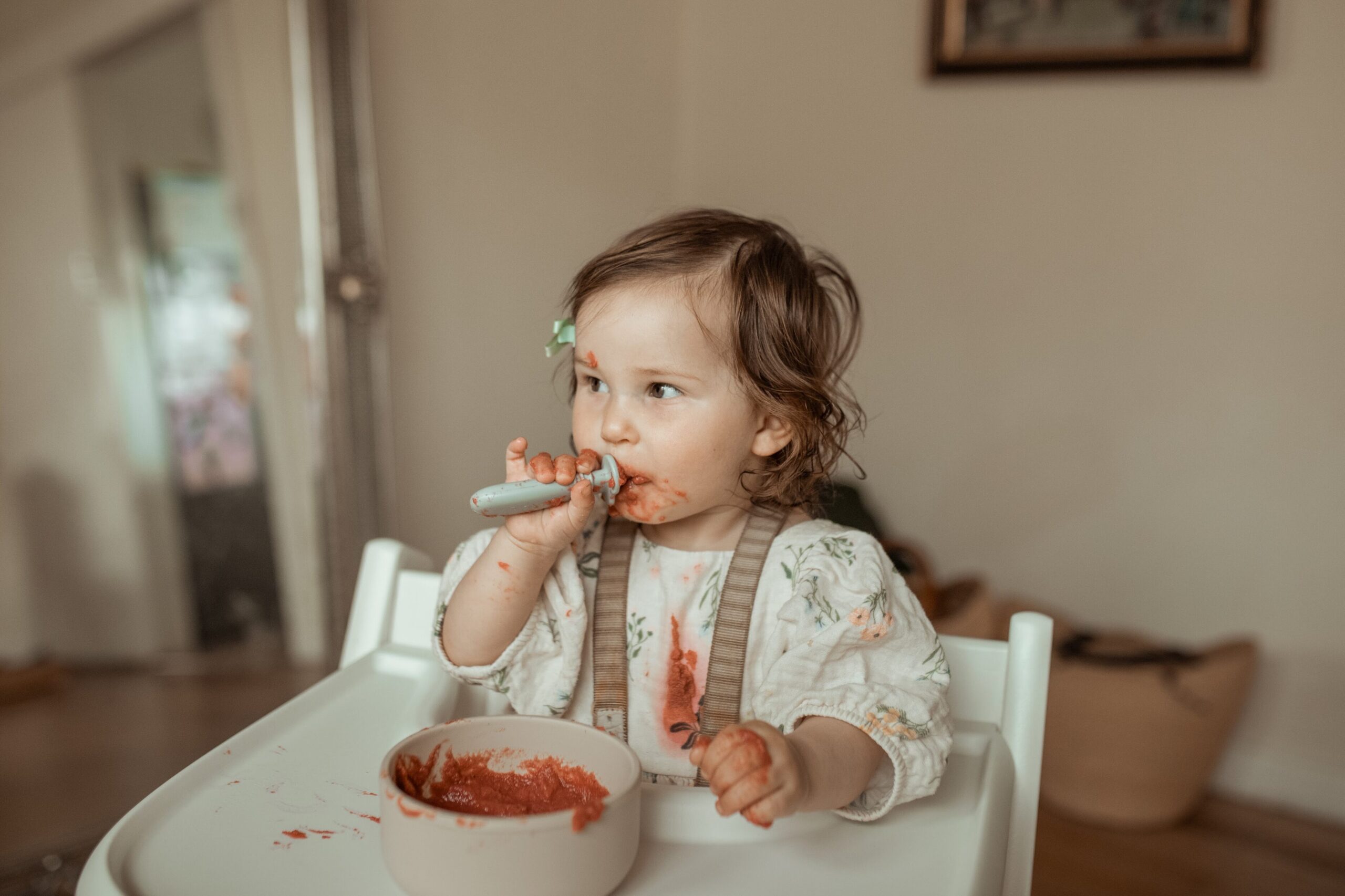 Baby eating baby food pouch